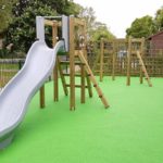 slide and climbing frame with green rubber flooring