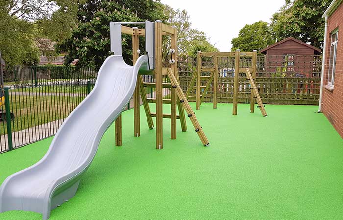 slide and climbing frame with green rubber flooring