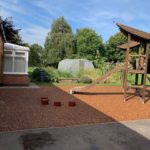 shot of wooden climbing frame with slide in shot c of e primary school