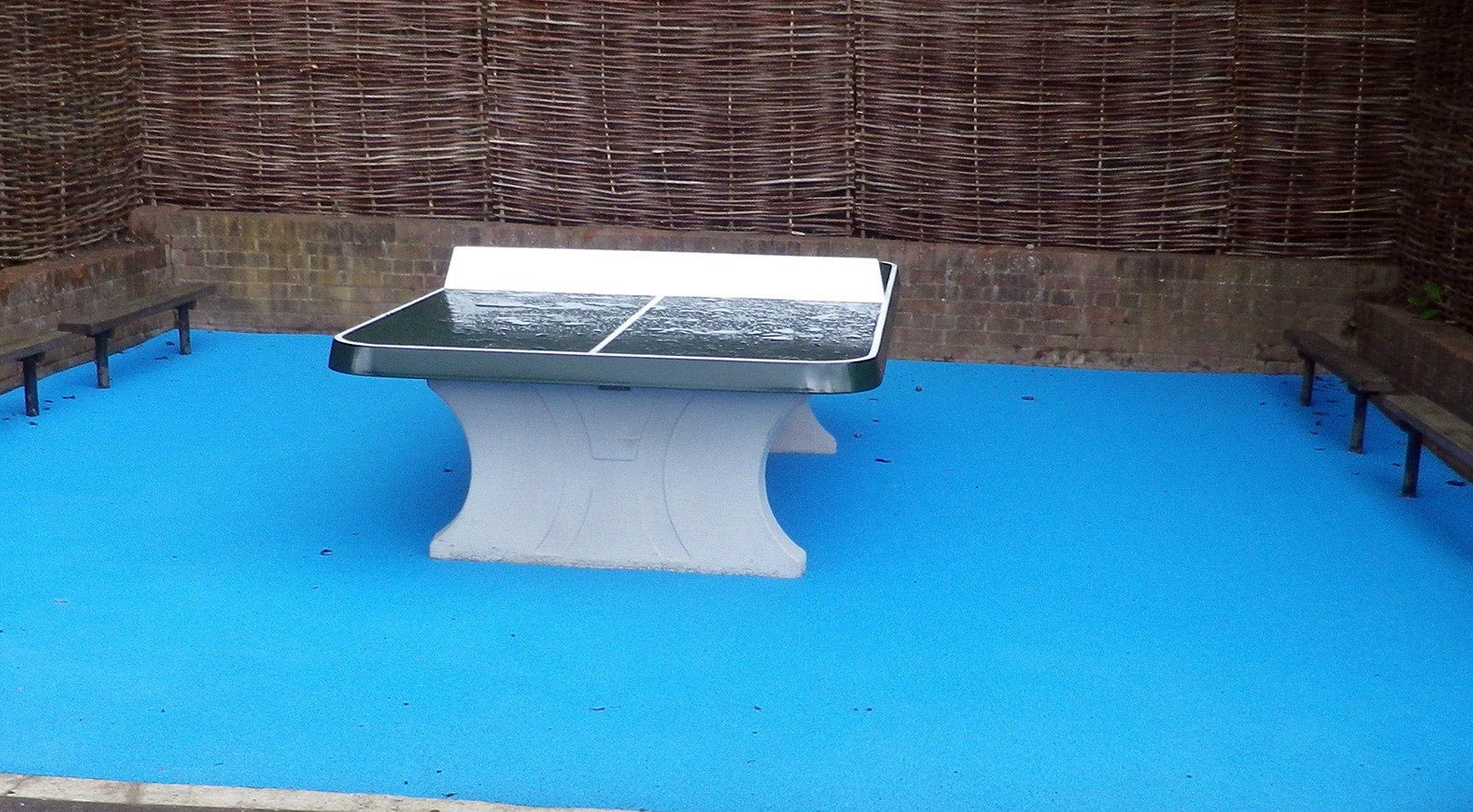 outdoor table tennis table on wet pour rubber surface