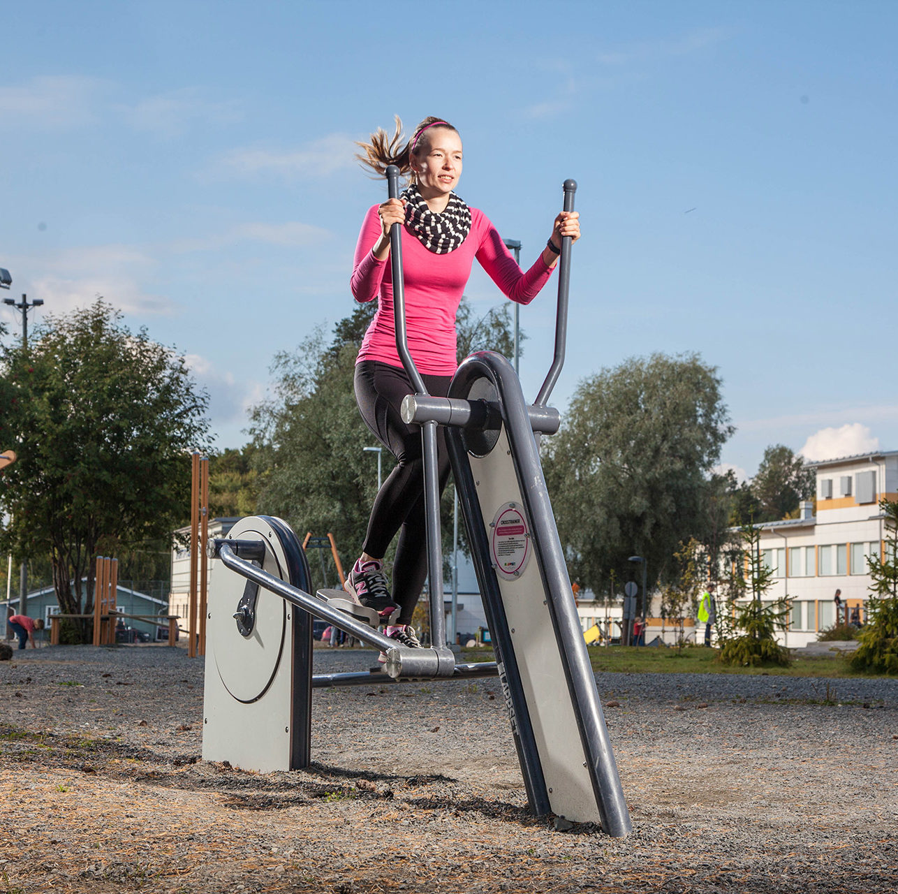 outdoor gym cross trainer being used by lady