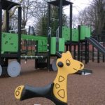close up of giraffe rocker in a playground