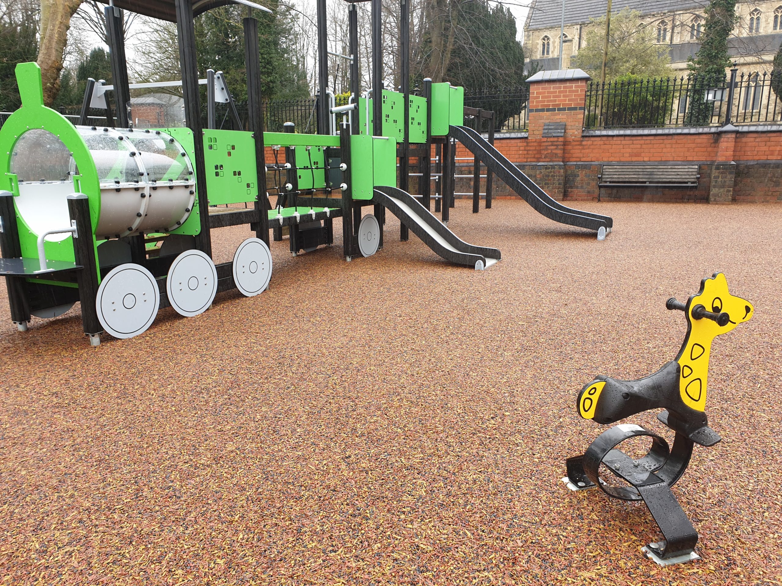 safe surfacing in a park with train climbing frame
