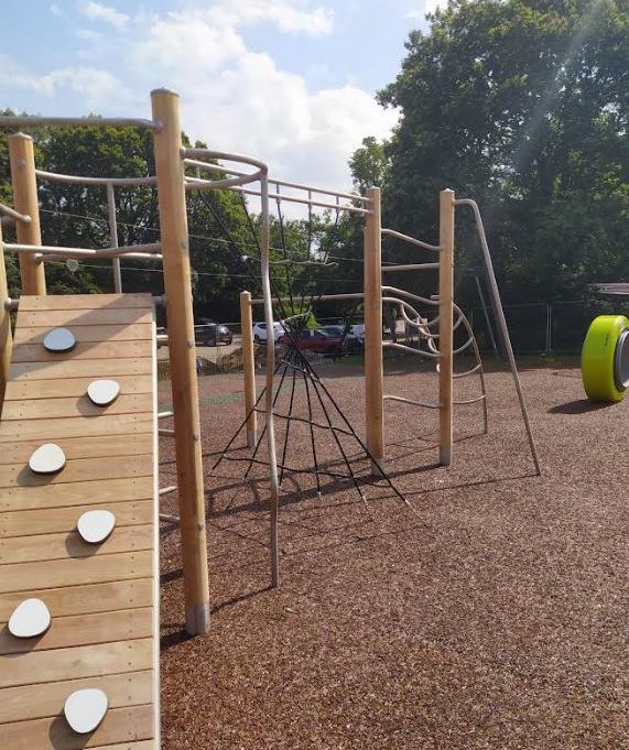 wooden climbing frame on rubber mulch safety surface
