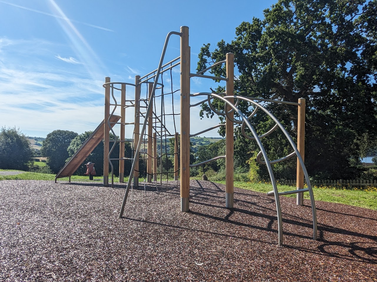 metal and wood climbing frame on rubber mulch