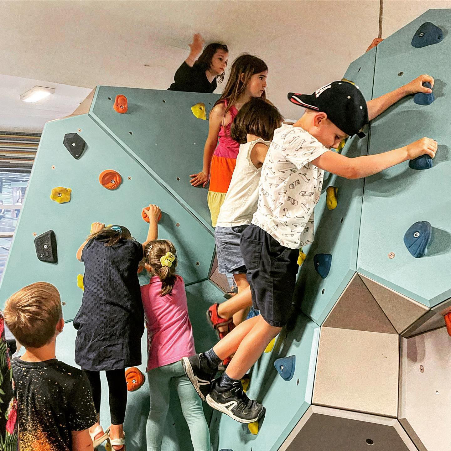 children on bouldering wall