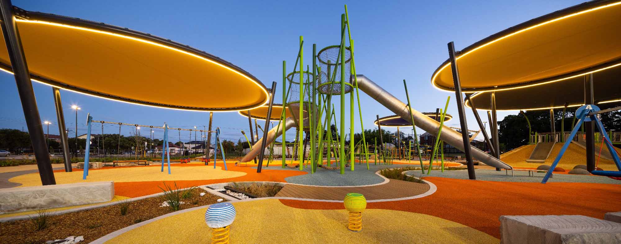 GrasArt playground equipment by Spiel Bau, blending with natural grass.