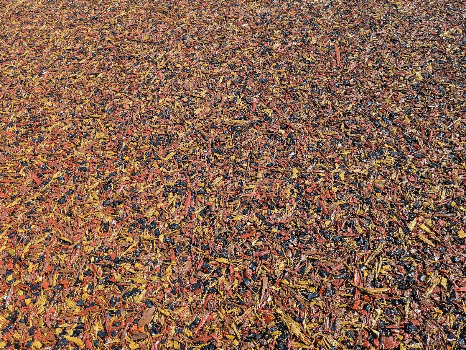 Close-up detail of TigerTrak surfacing showing colourful shredded rubber mulch
